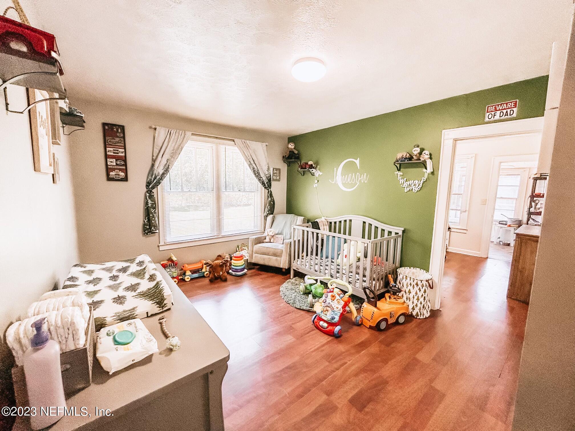 224 Benham Street Palatka, FL 32177 - Photo 7 of 15 a bedroom with furniture and a wooden floor