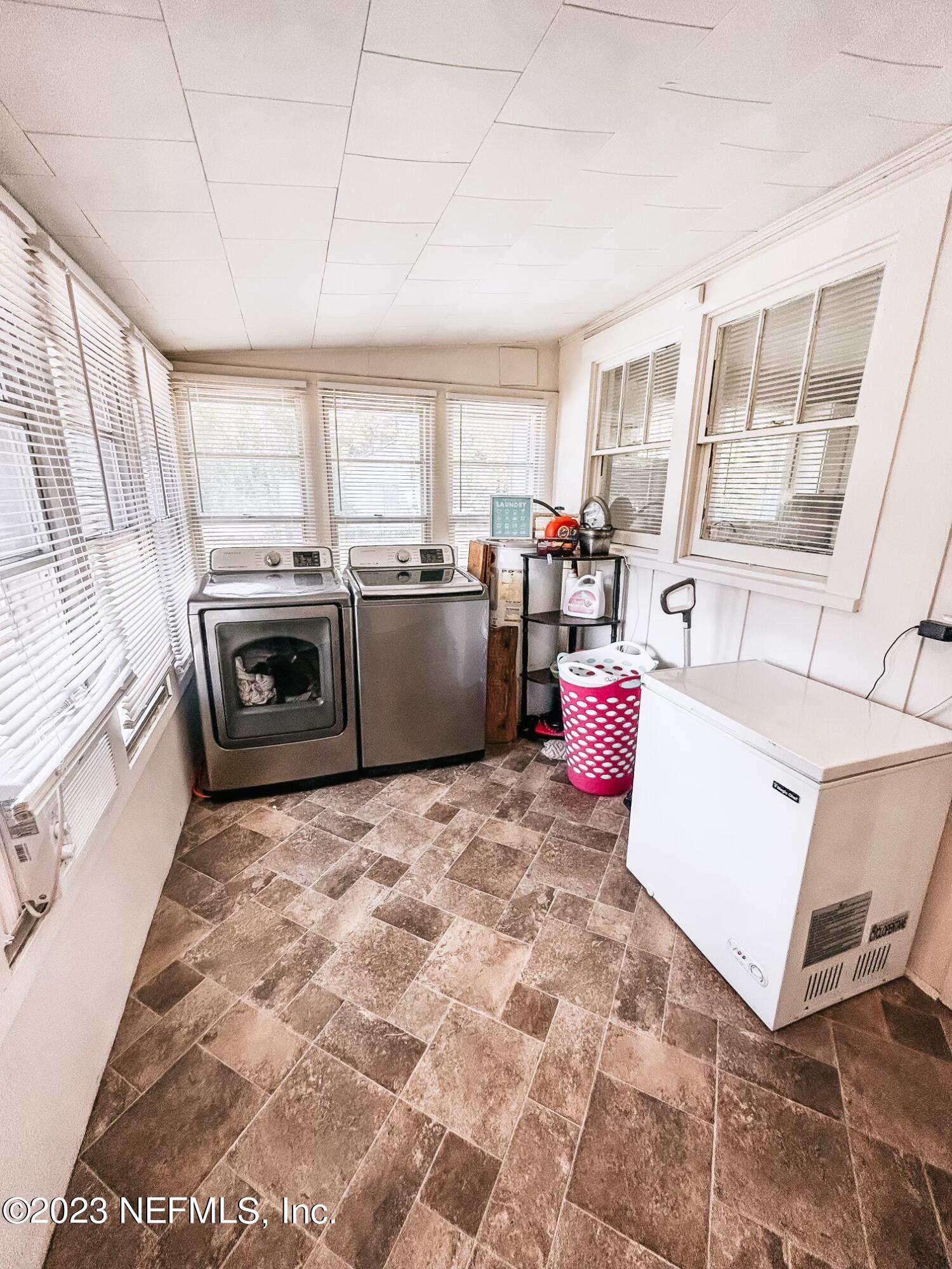 224 Benham Street Palatka, FL 32177 - Photo 8 of 15 a kitchen with a stove a sink and a refrigerator