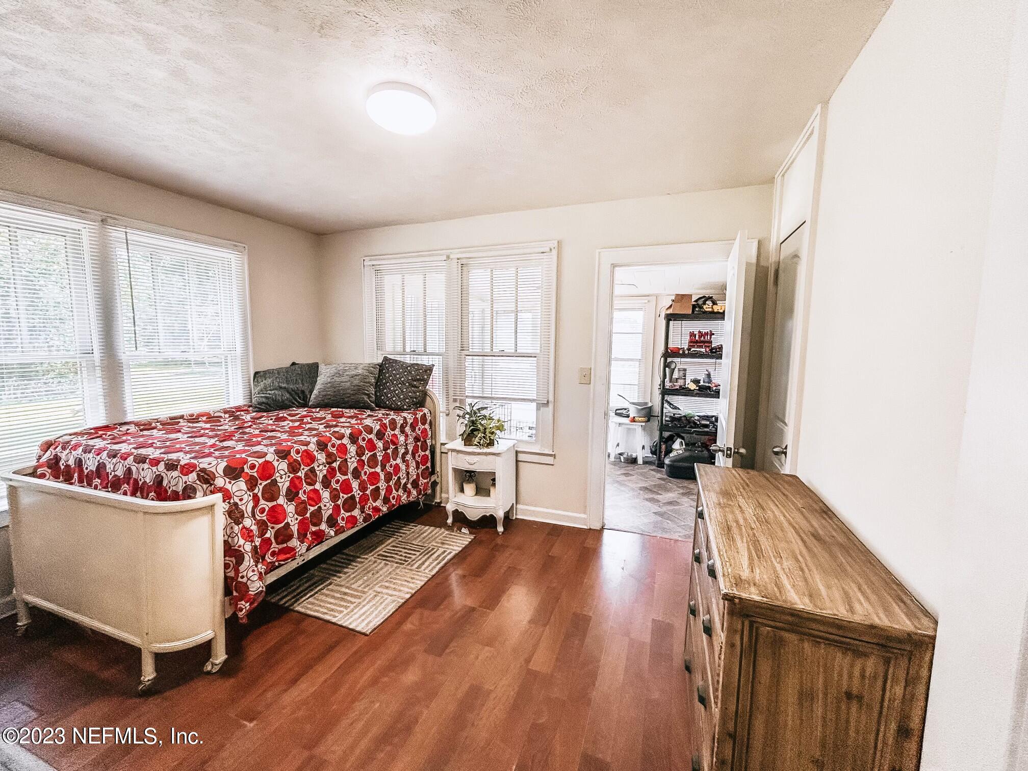 224 Benham Street Palatka, FL 32177 - Photo 9 of 15 a bedroom with a bed and wooden floor