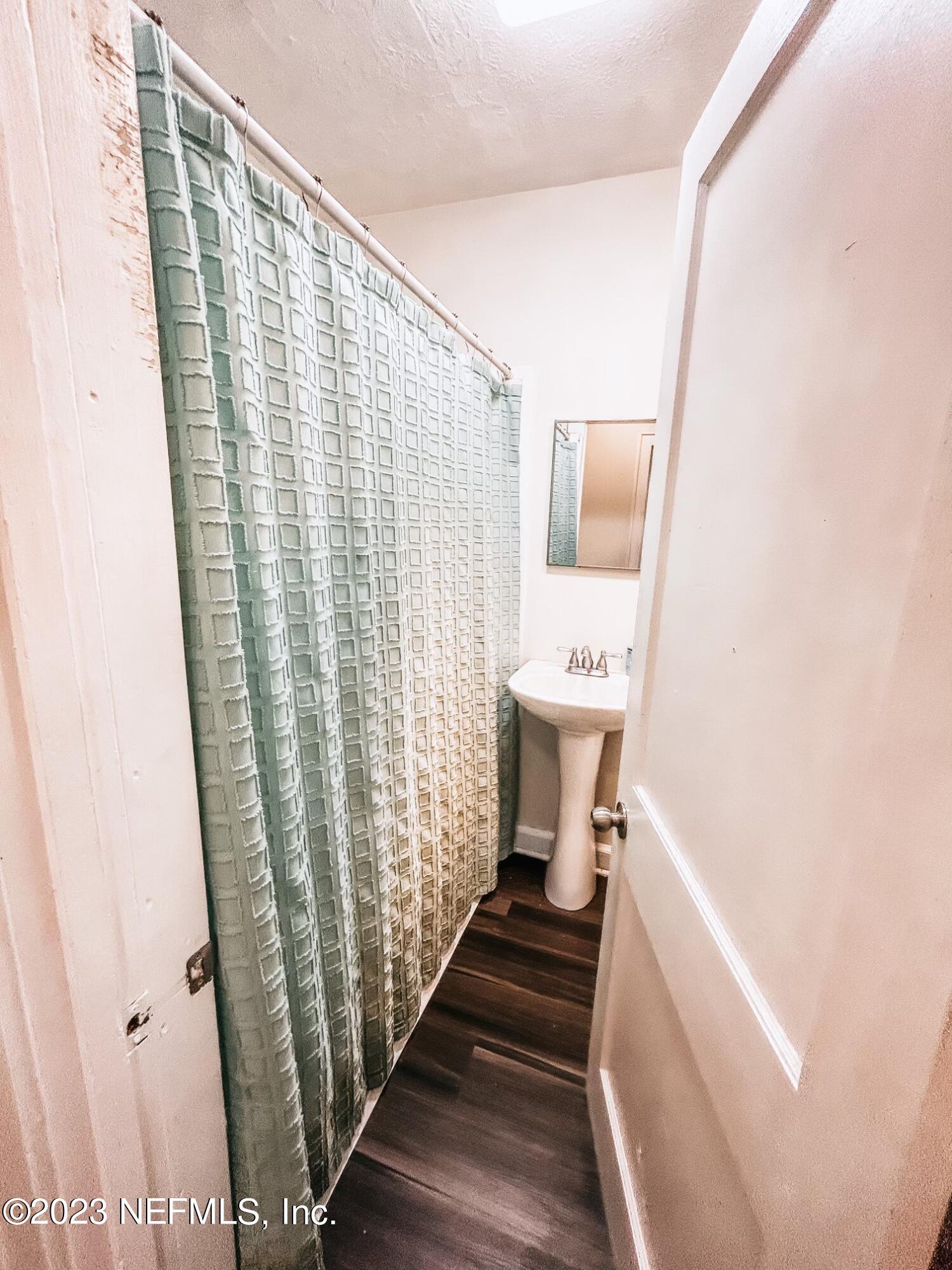 224 Benham Street Palatka, FL 32177 - Photo 10 of 15 a view of a hallway with wooden floor and staircase
