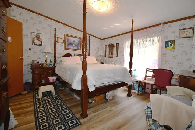 a bedroom with a bed a table and chair