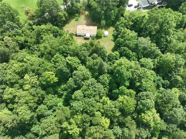 an aerial view of a house with yard