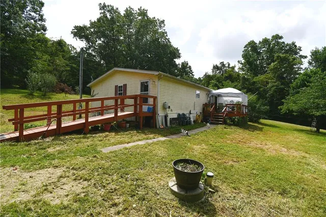 a view of a house with a yard and sitting area