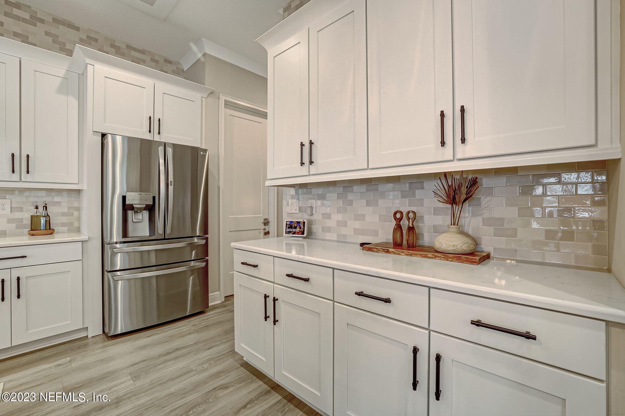 173 Rum Runner Way St. Johns, FL 32259 - Photo 20 of 104 a kitchen with granite countertop white cabinets and stainless steel appliances