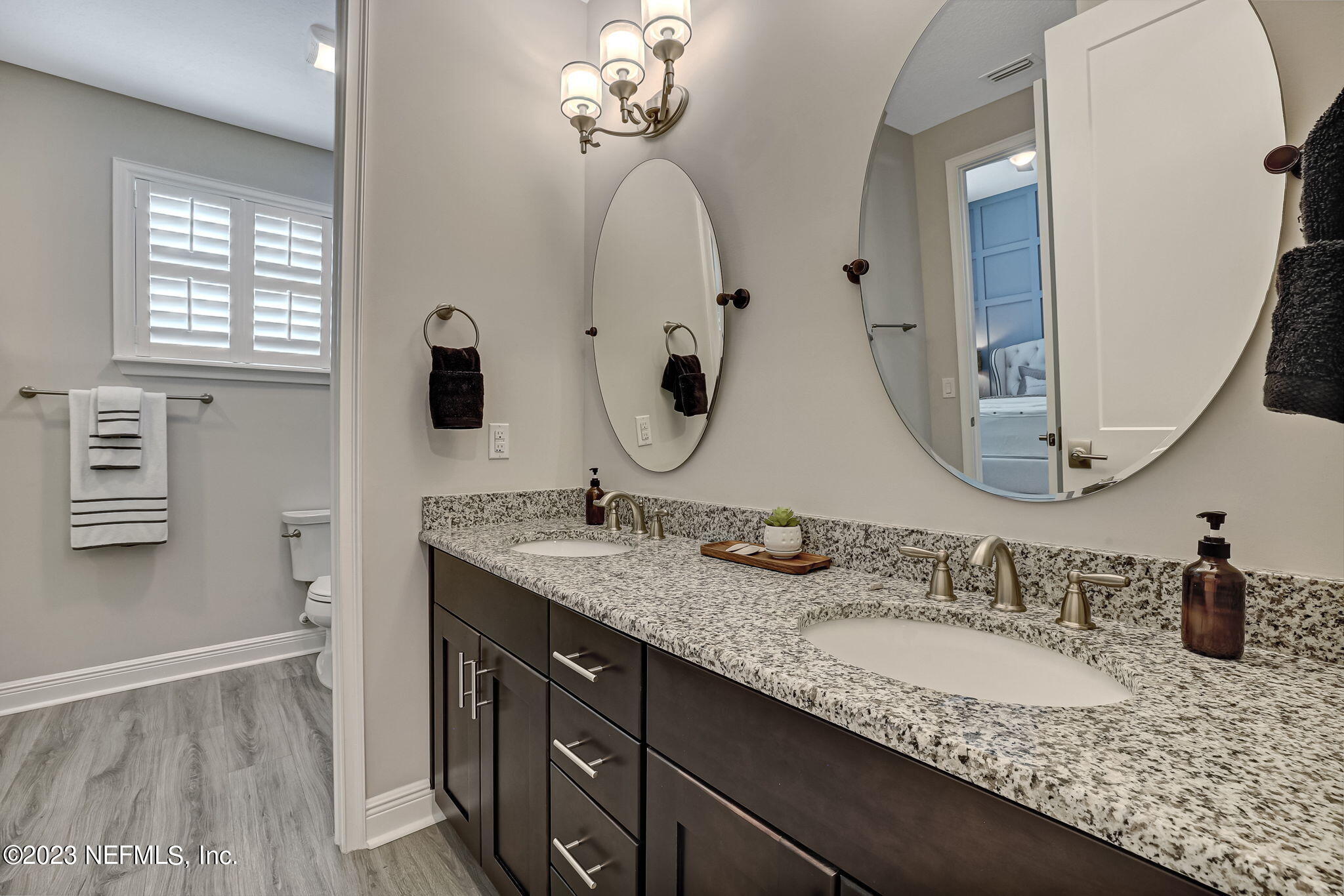 173 Rum Runner Way St. Johns, FL 32259 - Photo 52 of 104 a bathroom with a granite countertop sink and a mirror