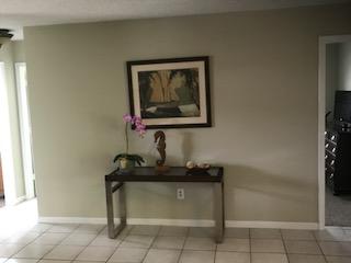 10907 Gable Street Boca Raton, FL 33428 - Photo 28 of 40 a living room with a couch and a potted plant