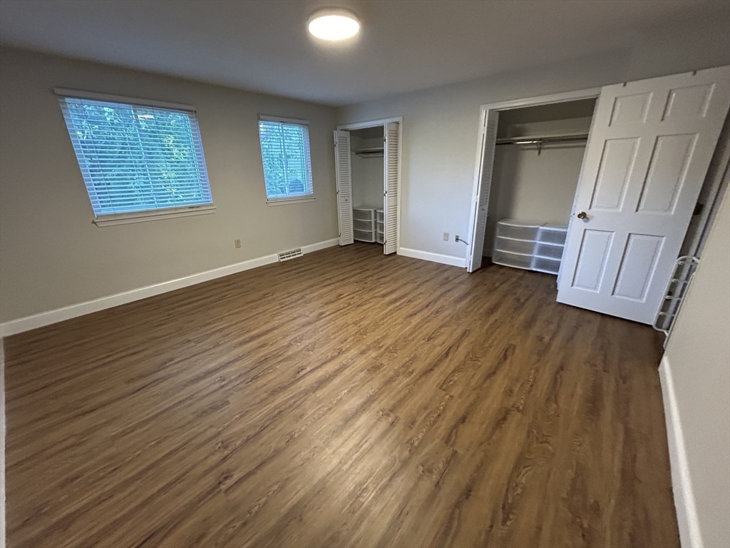 28 Apple Tree Hill Road, Unit 28 Hopkinton, MA 01748 - Photo 12 of 20 a view of empty room with wooden floor and fan