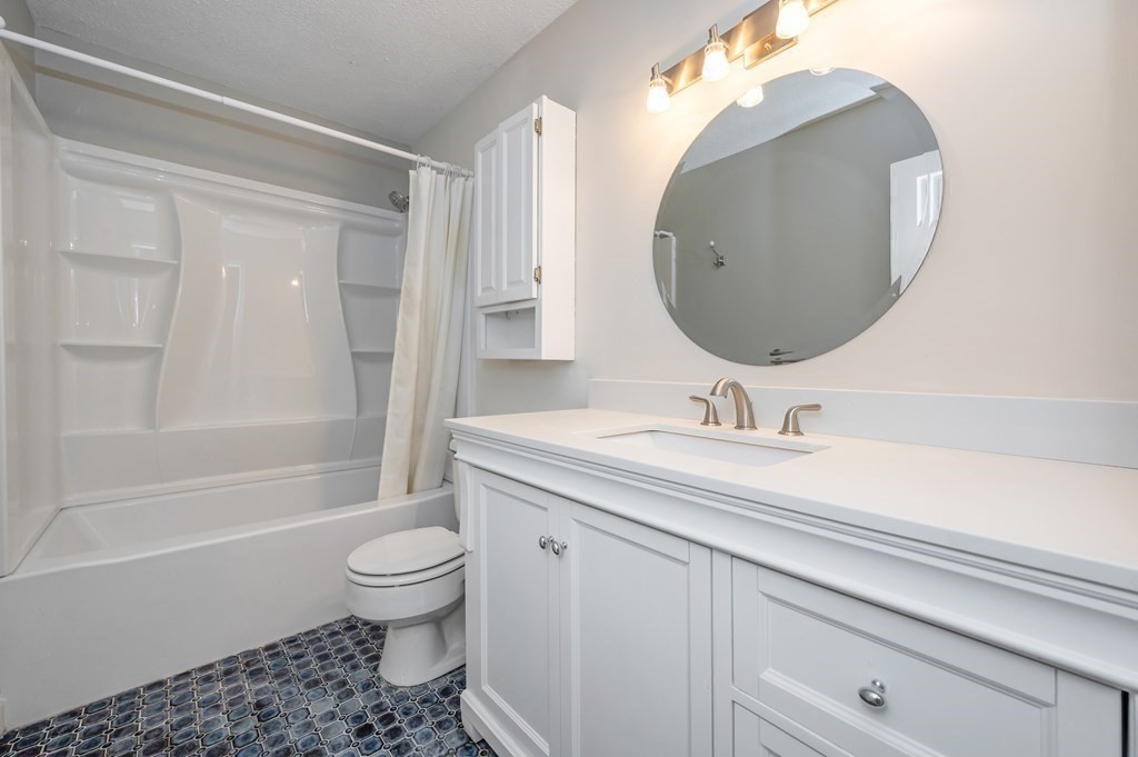 28 Apple Tree Hill Road, Unit 28 Hopkinton, MA 01748 - Photo 13 of 20 a bathroom with a granite countertop sink a toilet and a mirror
