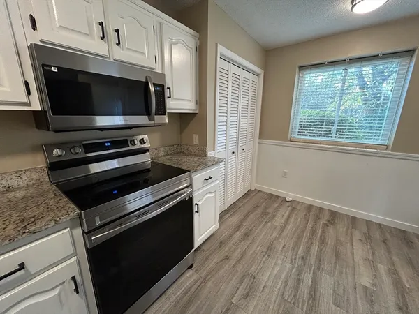 a kitchen with a stove and a microwave