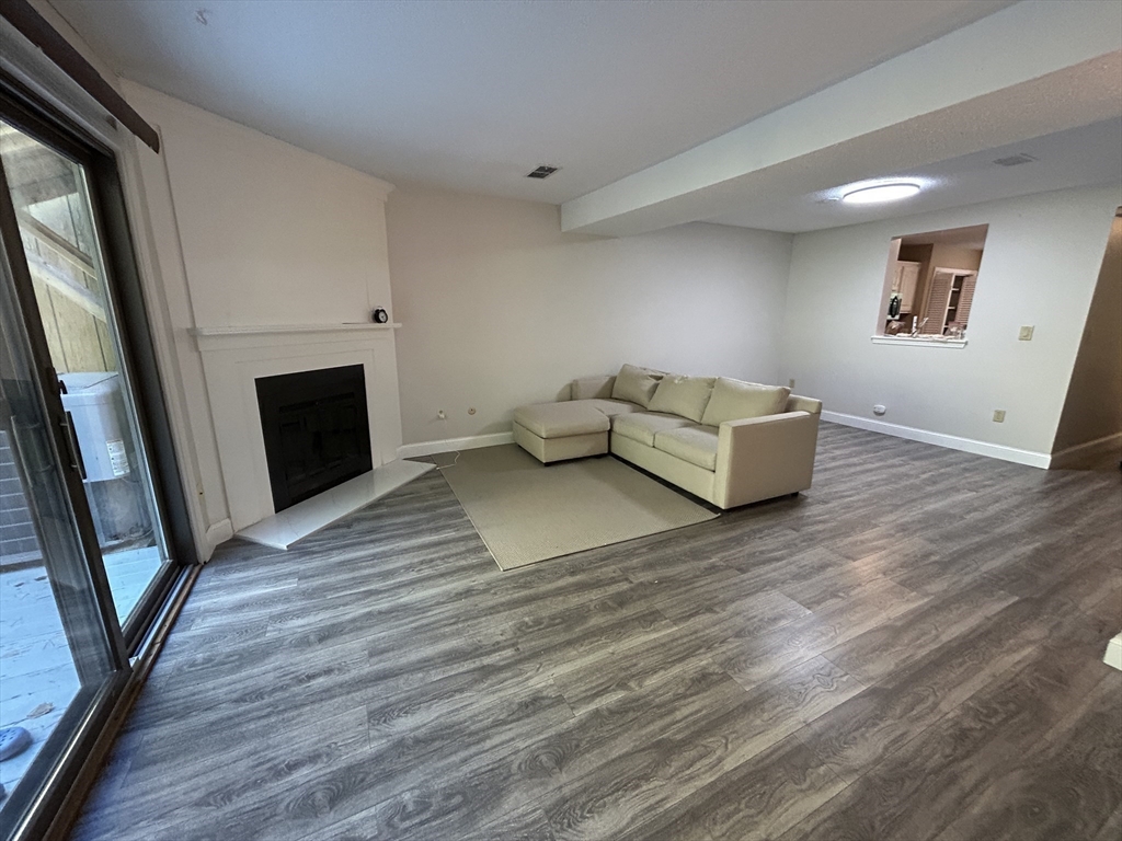 28 Apple Tree Hill Road, Unit 28 Hopkinton, MA 01748 - Photo 4 of 20 a living room with furniture and a fireplace