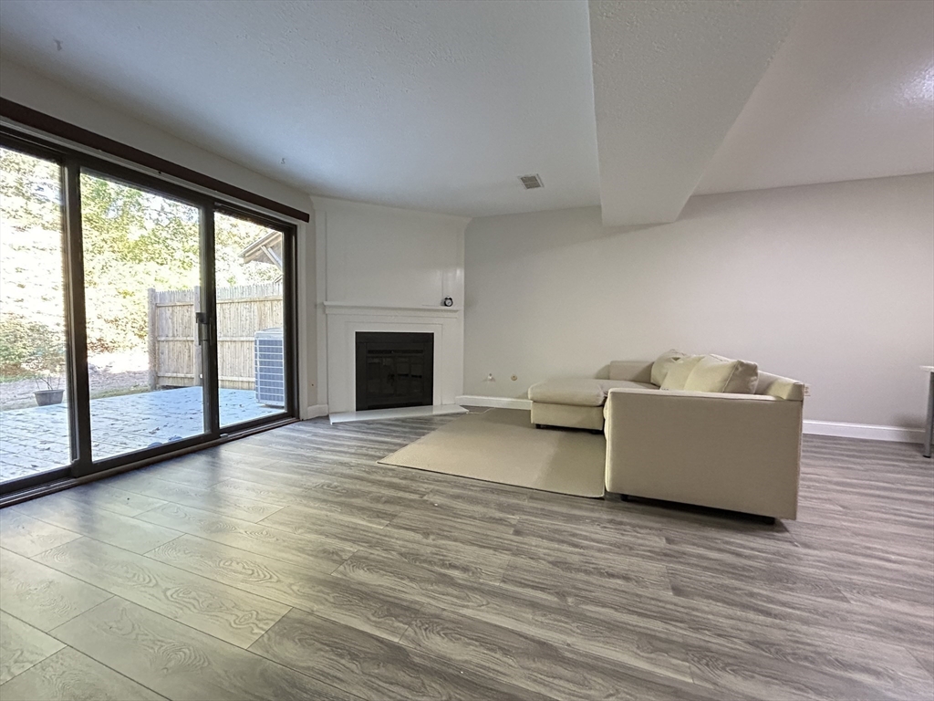 28 Apple Tree Hill Road, Unit 28 Hopkinton, MA 01748 - Photo 5 of 20 a living room with furniture and a fireplace