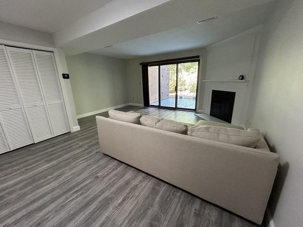 28 Apple Tree Hill Road, Unit 28 Hopkinton, MA 01748 - Photo 6 of 20 a living room with a couch and a window