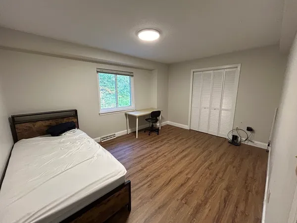 a room with a bed and window