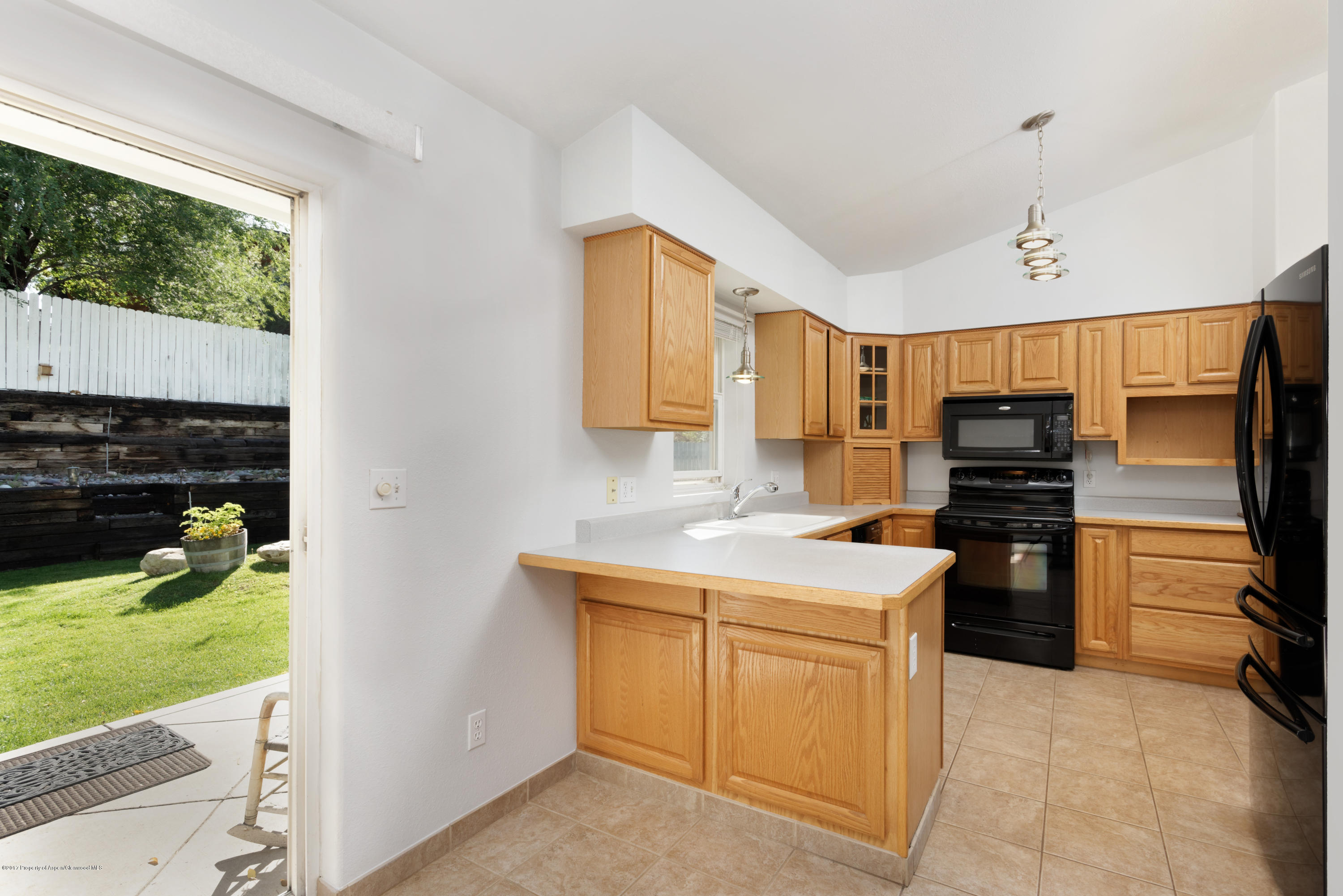 776 Munro Avenue Rifle, CO 81650 - Photo 13 of 24 a kitchen with a sink stainless steel appliances and cabinets