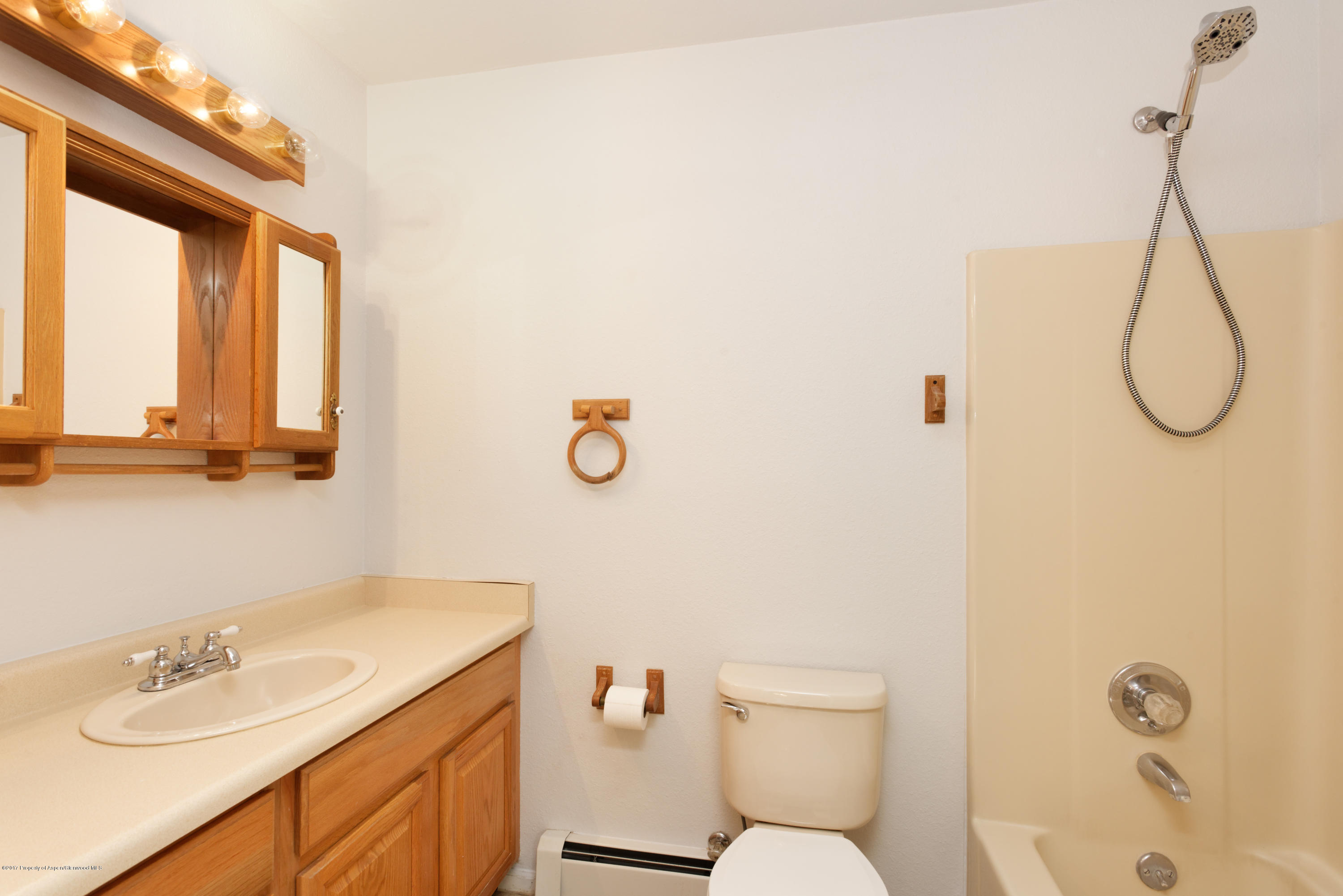776 Munro Avenue Rifle, CO 81650 - Photo 16 of 24 a bathroom with a granite countertop sink a toilet and a mirror