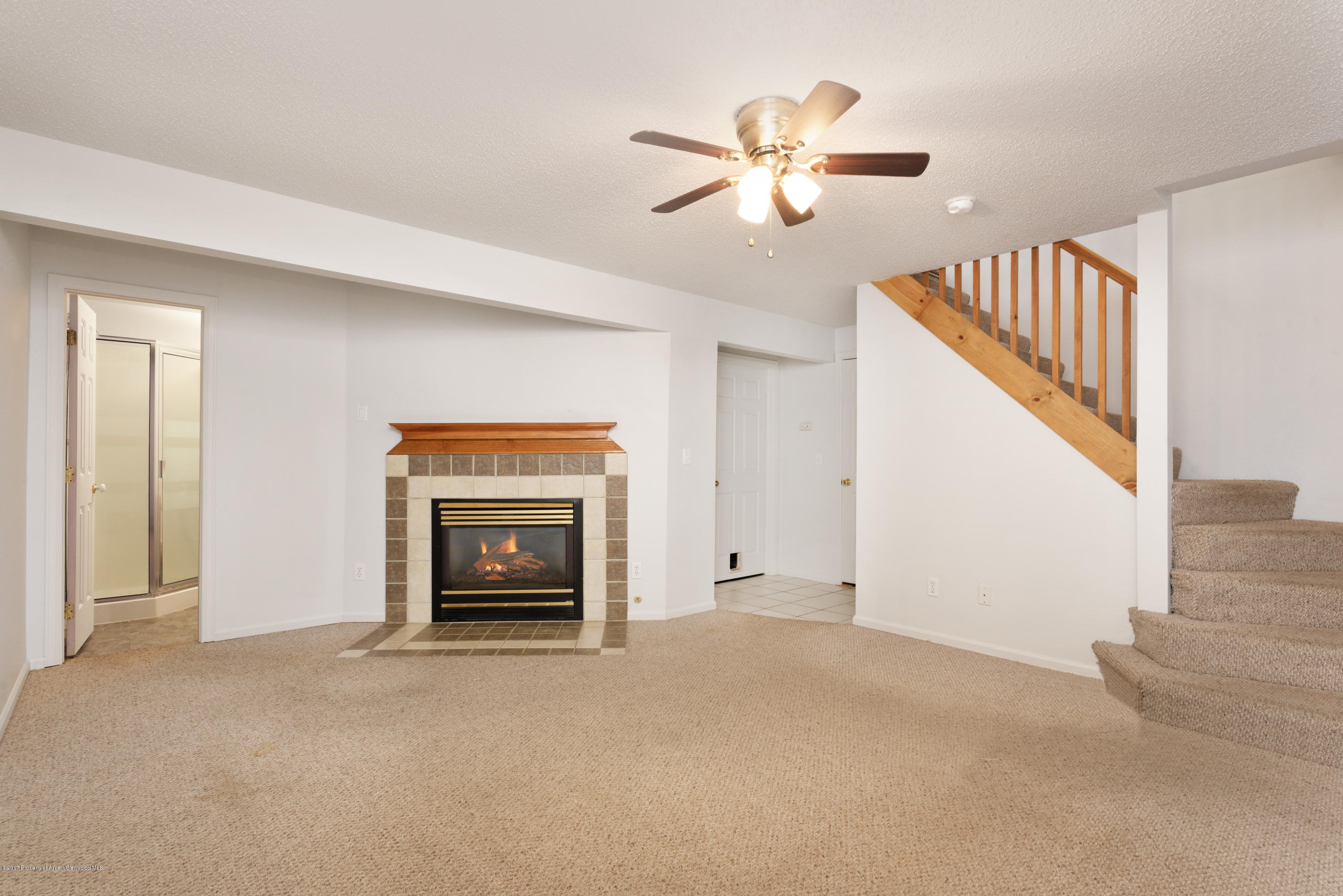 776 Munro Avenue Rifle, CO 81650 - Photo 20 of 24 a view of an empty room with chandelier fan and fire place