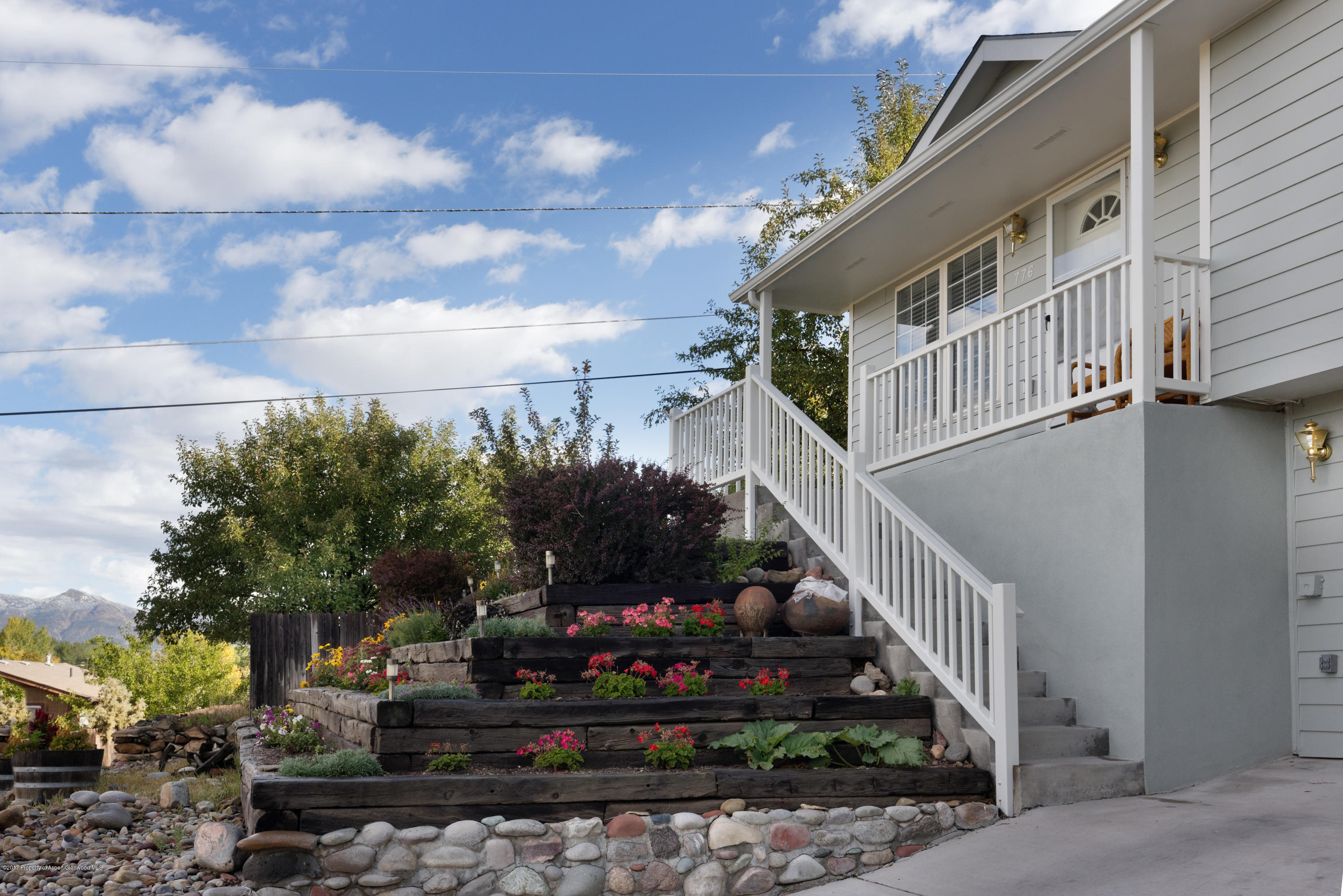 776 Munro Avenue Rifle, CO 81650 - Photo 4 of 24 a view of a house with a yard and potted plants