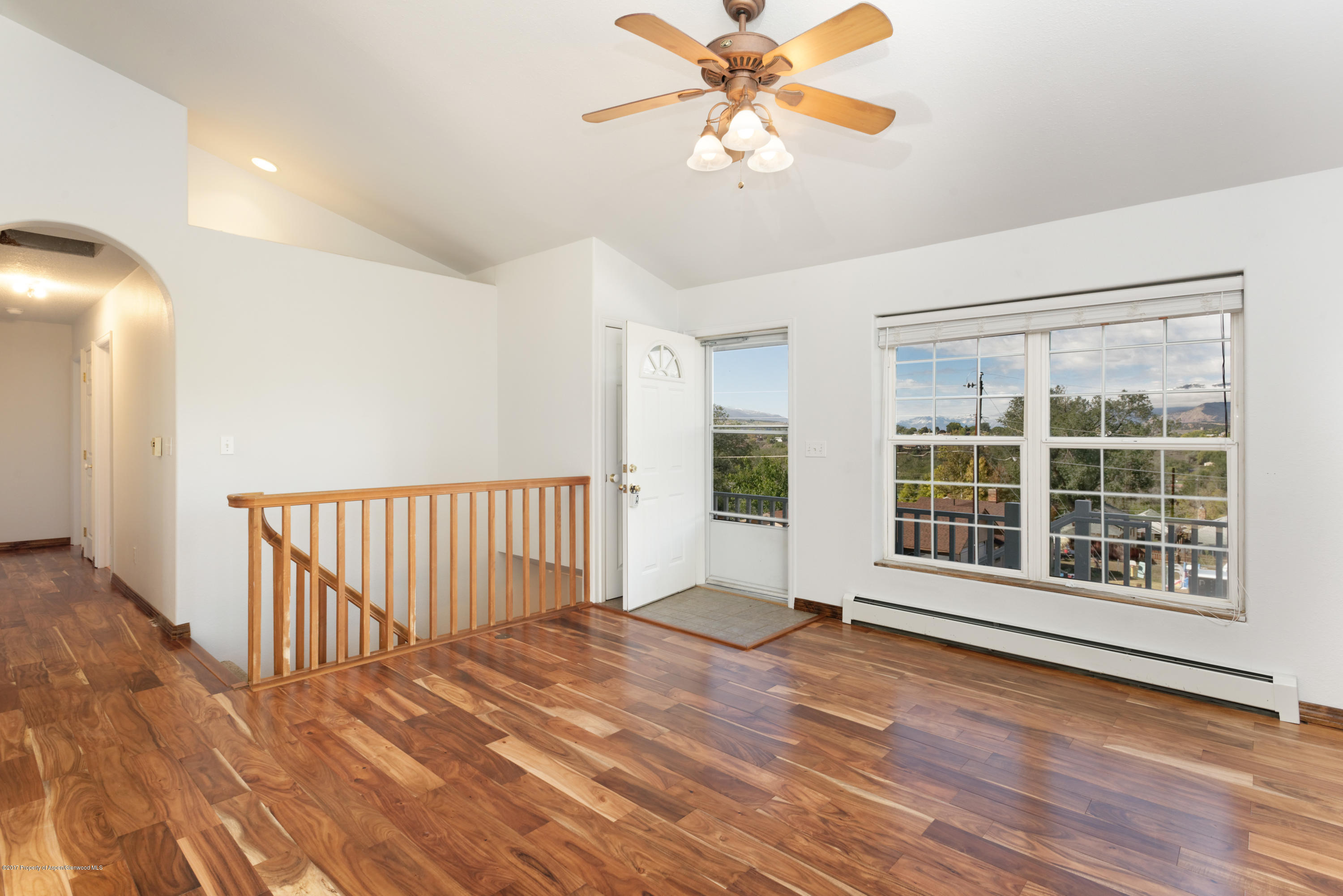 776 Munro Avenue Rifle, CO 81650 - Photo 10 of 24 a view of an empty room with a window and wooden floor