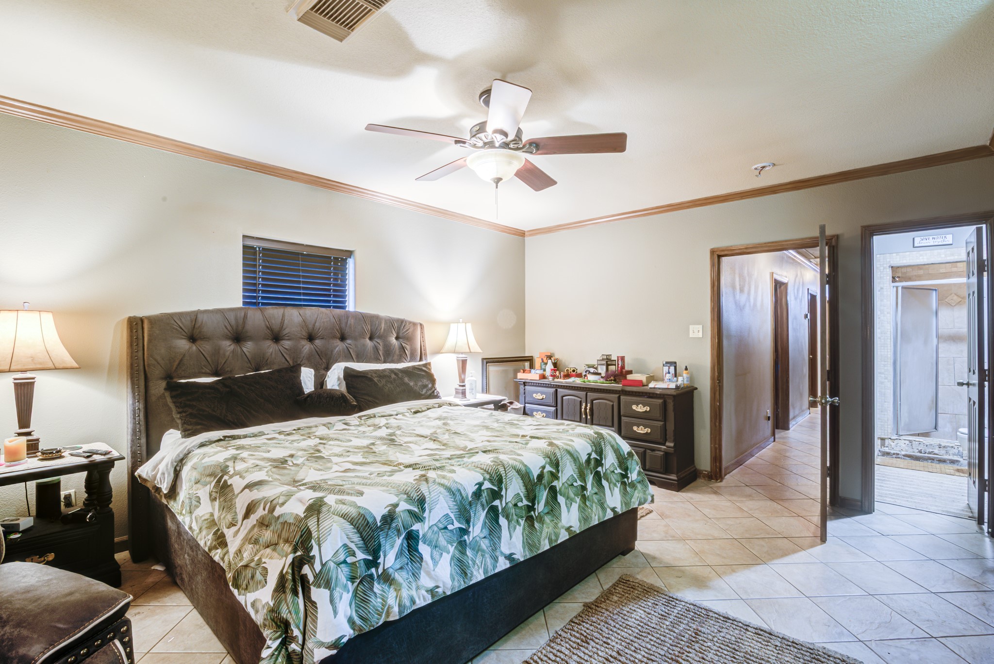 8123 Tareyton Lane Houston, TX 77075 - Photo 17 of 27 a bedroom with a bed and a chandelier