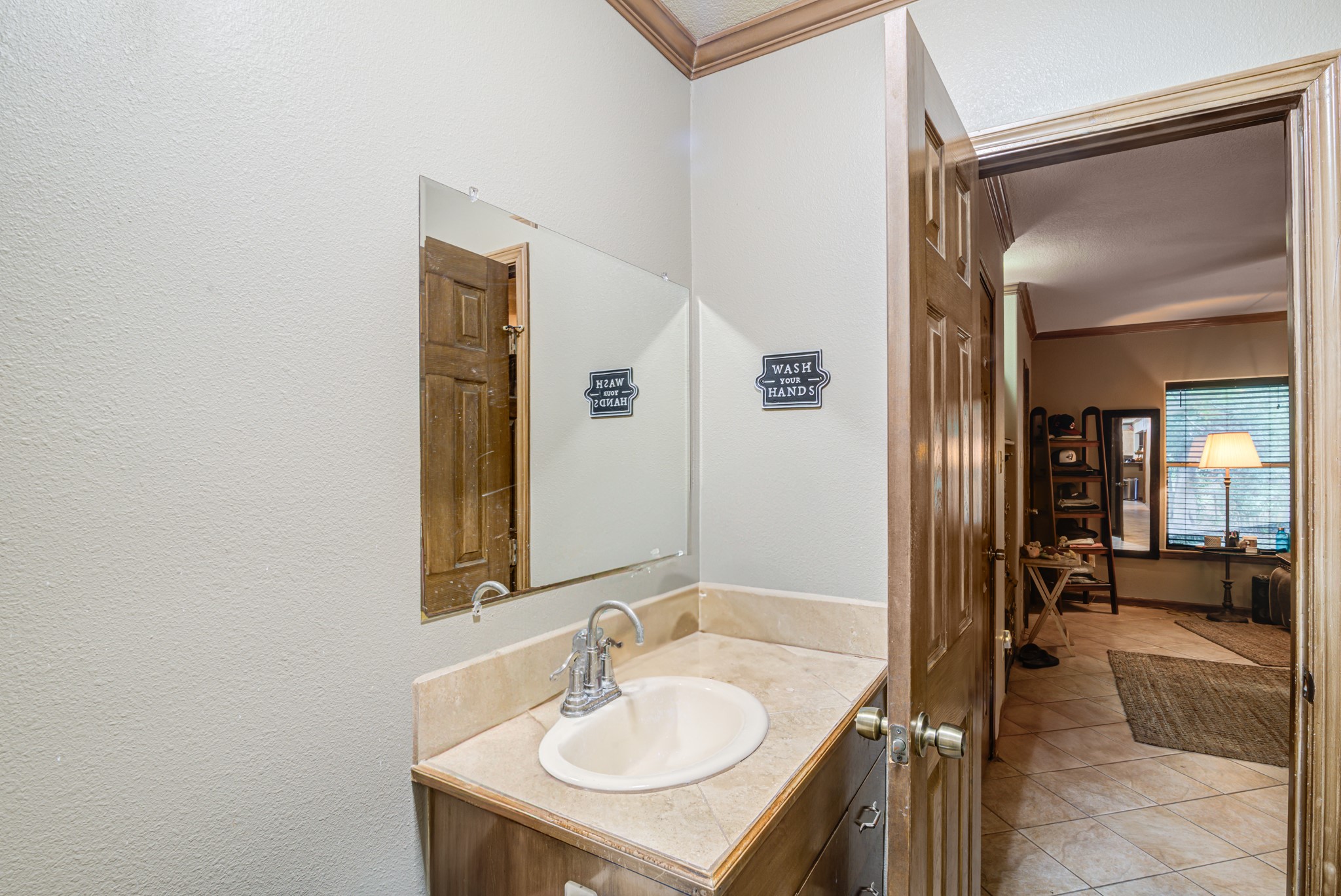 8123 Tareyton Lane Houston, TX 77075 - Photo 19 of 27 a en suite bathroom with a sink and a mirror