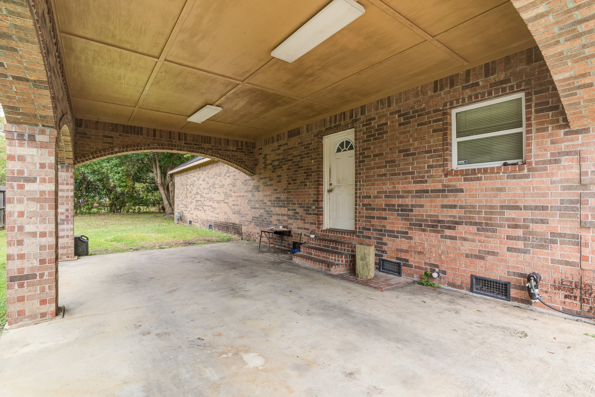 8123 Tareyton Lane Houston, TX 77075 - Photo 21 of 27 a view of a backyard with table and chairs under an umbrella