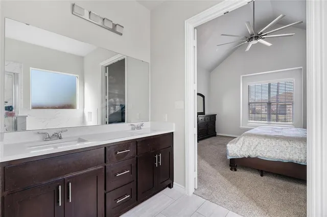 a en suite bathroom with a double vanity sink double vanity and a mirror
