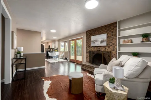 a living room with furniture large window and a fireplace