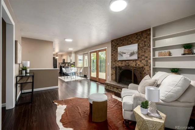 a living room with furniture large window and a fireplace