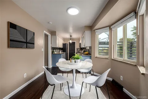 a view of a dining room with furniture window and wooden floor