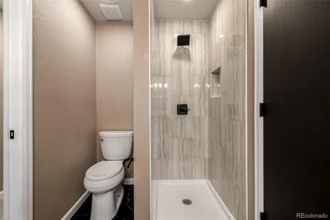 a bathroom with a shower and a toilet