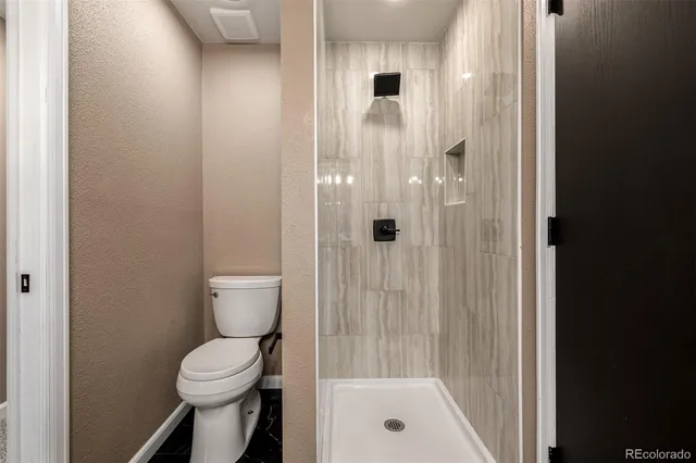 a bathroom with a shower and a toilet