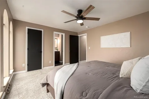 a bedroom with a large bed and a chandelier