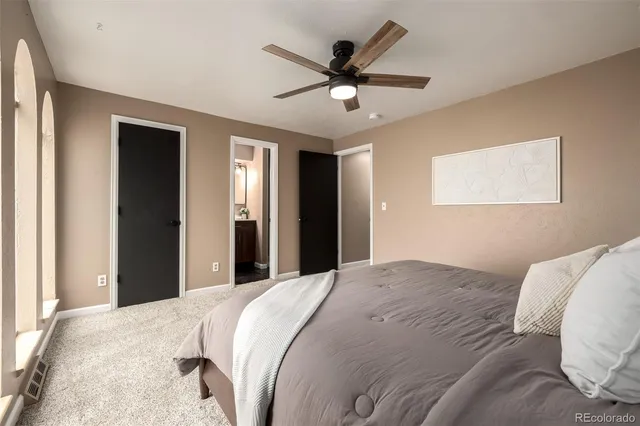 a bedroom with a large bed and a chandelier