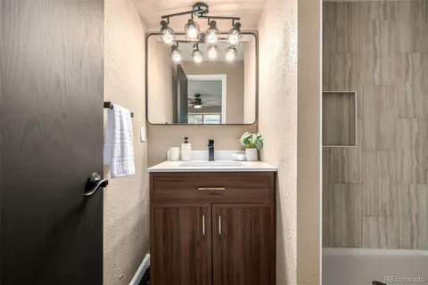 a bathroom with a sink vanity and a mirror