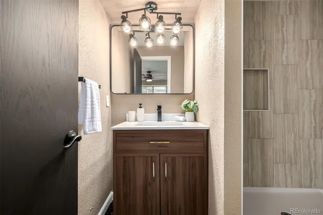 a bathroom with a sink vanity and a mirror
