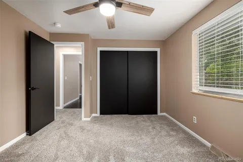 an empty room with windows and closet