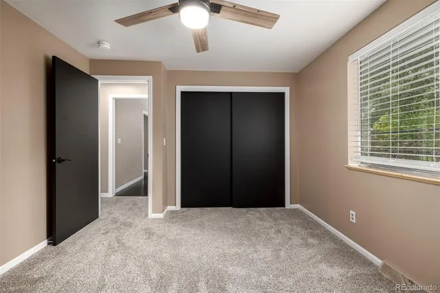 an empty room with windows and closet