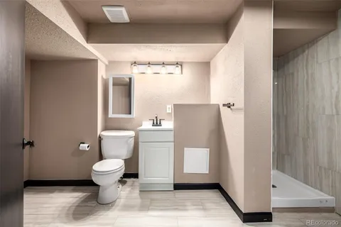a bathroom with a toilet and a shower