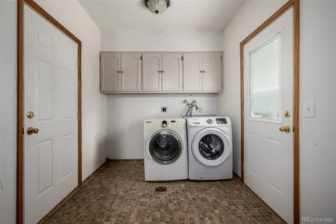 a utility room with sink dryer and washer