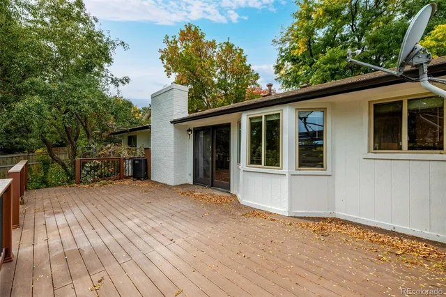 a view of backyard with a deck and wooden floor
