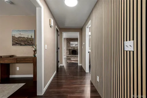 a view of a hallway with wooden floor and staircase