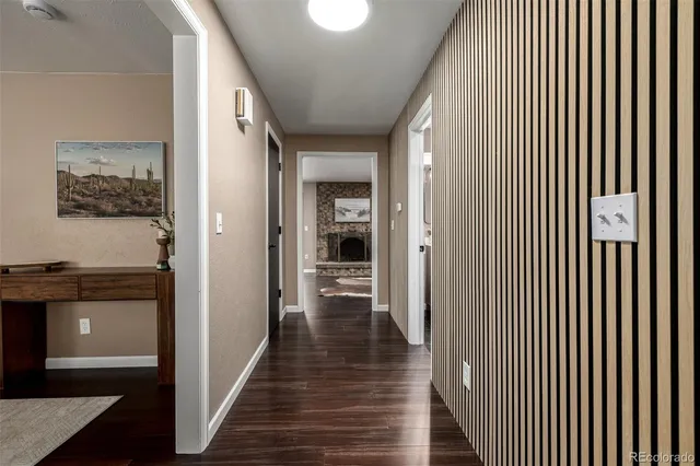 a view of a hallway with wooden floor and staircase