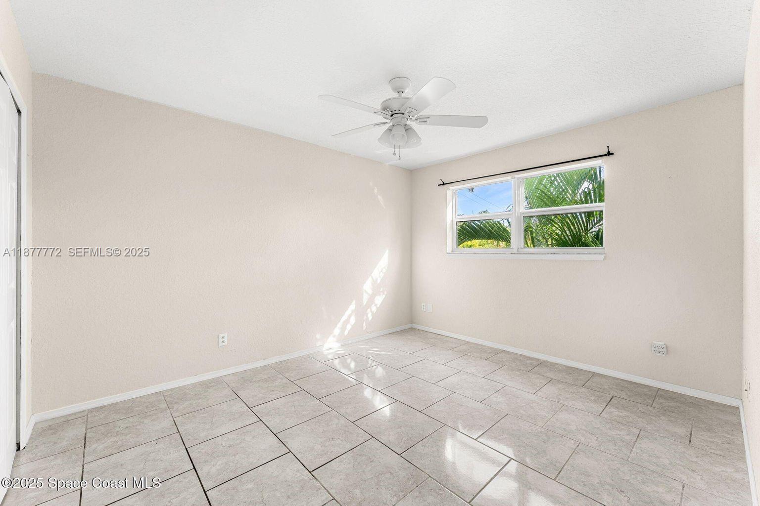 220 Columbia Drive, Unit 31 Cape Canaveral, FL 32920 - Photo 11 of 23 an empty room with windows and fan