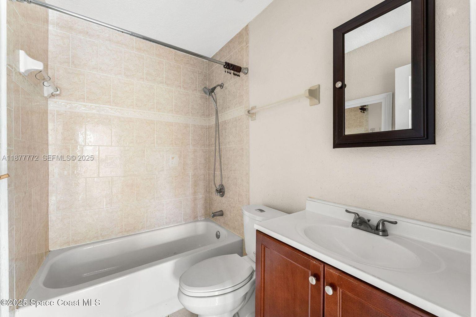 220 Columbia Drive, Unit 31 Cape Canaveral, FL 32920 - Photo 12 of 23 a bathroom with a sink a toilet and shower