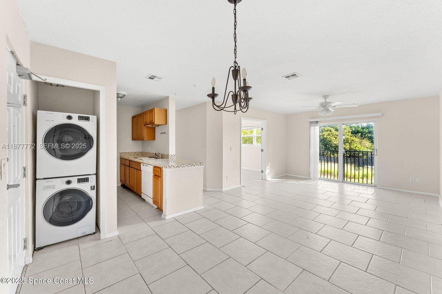 220 Columbia Drive, Unit 31 Cape Canaveral, FL 32920 - Photo 18 of 23 a view of a kitchen with a sink and a washer dryer