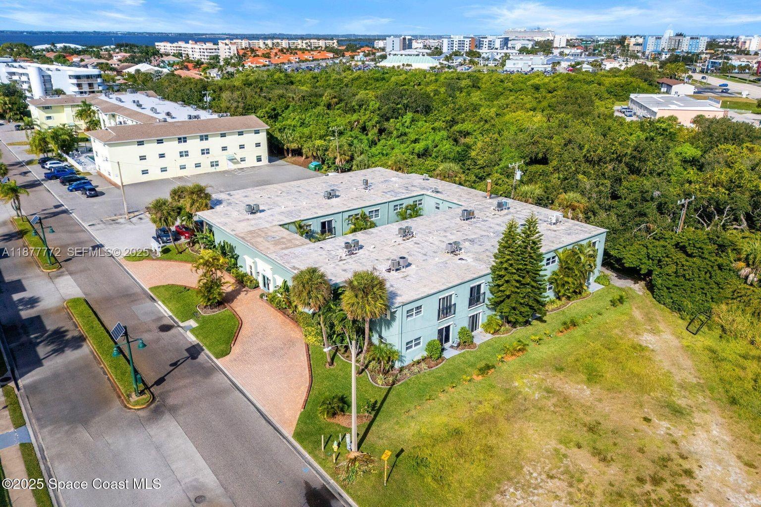 220 Columbia Drive, Unit 31 Cape Canaveral, FL 32920 - Photo 2 of 23 an aerial view of a house with a yard