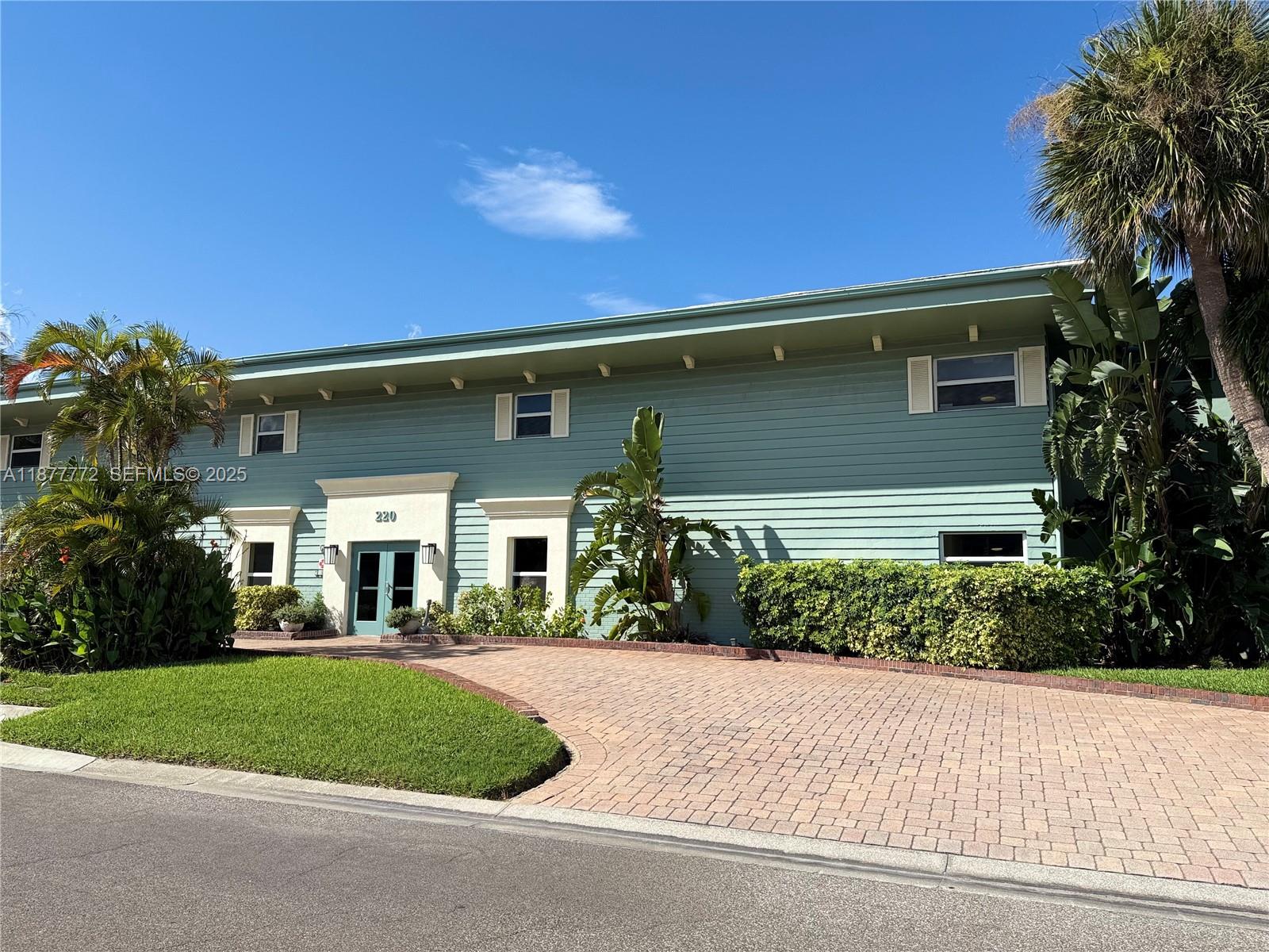 220 Columbia Drive, Unit 31 Cape Canaveral, FL 32920 - Photo 4 of 23 a front view of a house with a yard