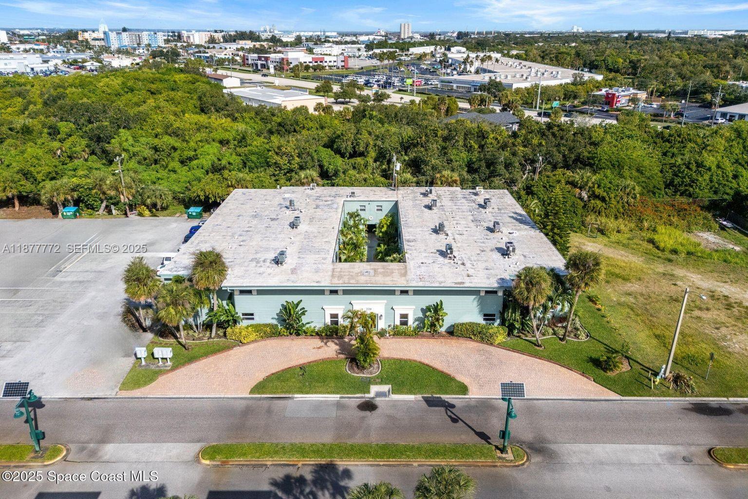 220 Columbia Drive, Unit 31 Cape Canaveral, FL 32920 - Photo 6 of 23 an aerial view of a house with a swimming pool
