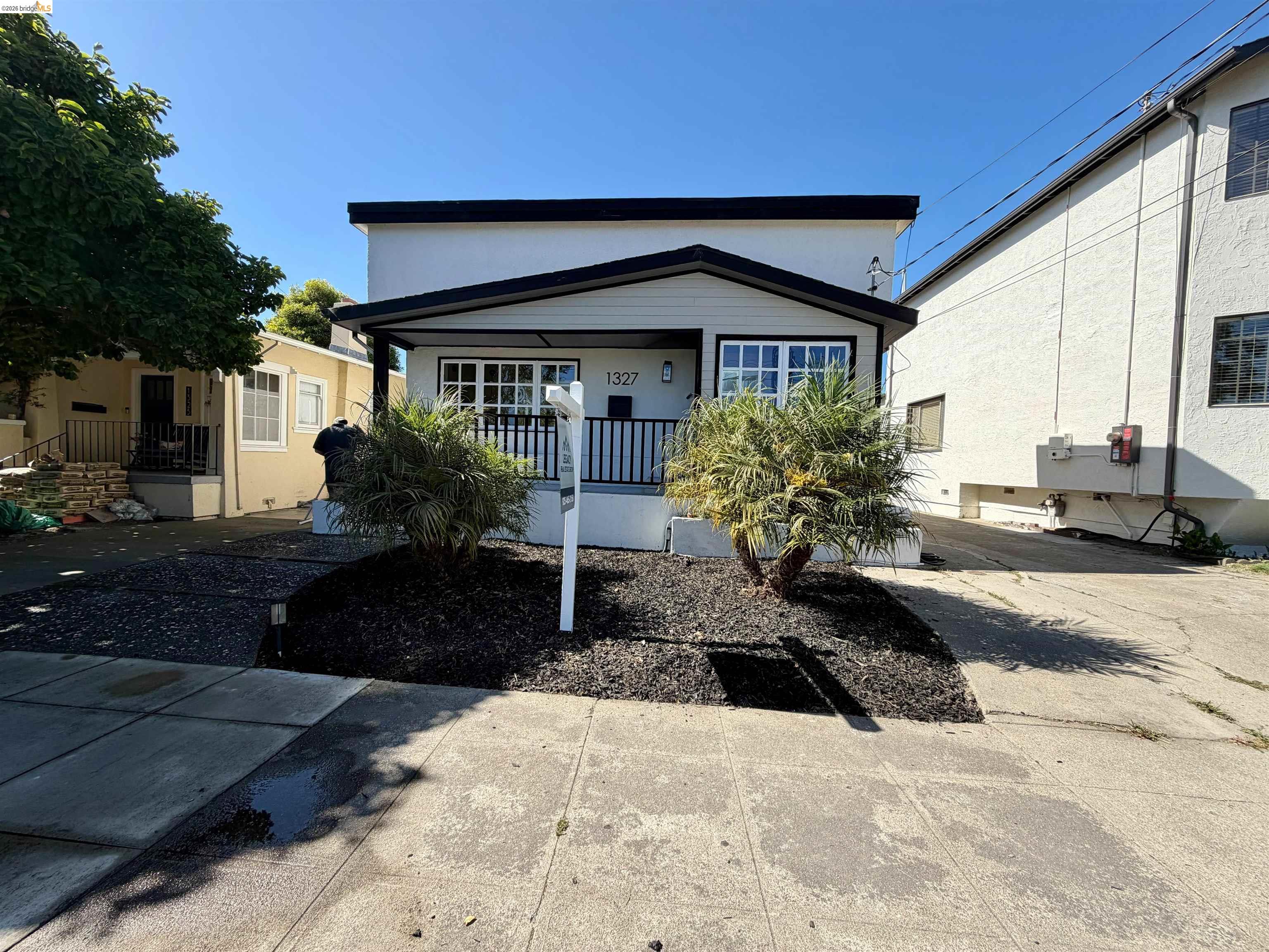 1327 Ward Street Berkeley, CA 94702 - Photo 1 of 8 a front view of a house with garden