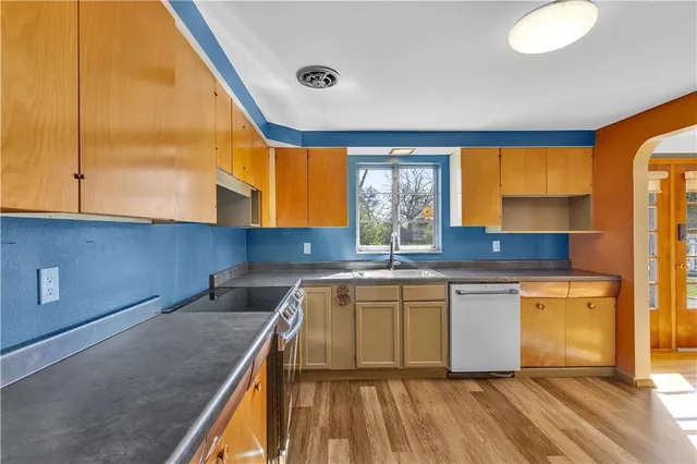 a kitchen with stainless steel appliances granite countertop a sink and a cabinets